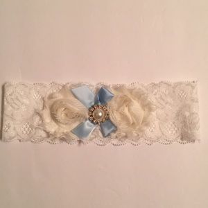 White and ivory lace garter with blue ribbon